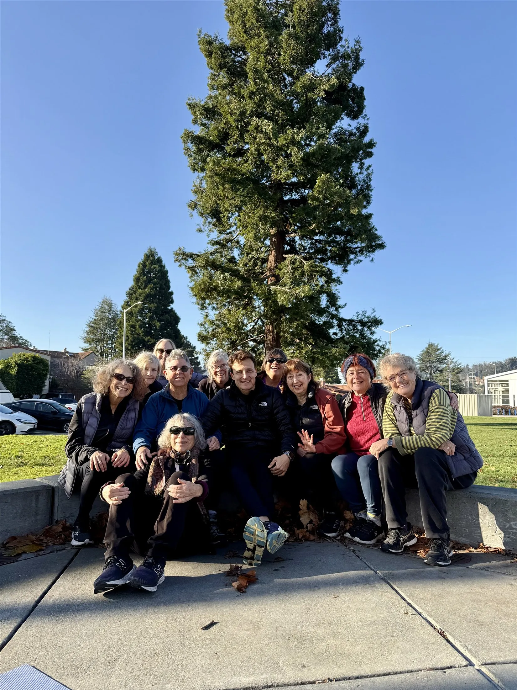 Dario with his senior training group gathered outdoors under a redwood