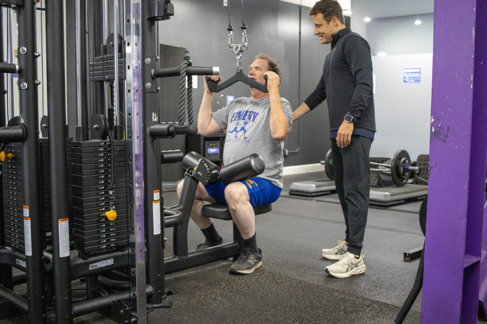 Guiding a senior client through a strength machine