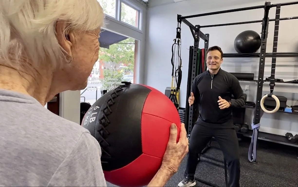 Dario Mathias coaching a medicine-ball exercise